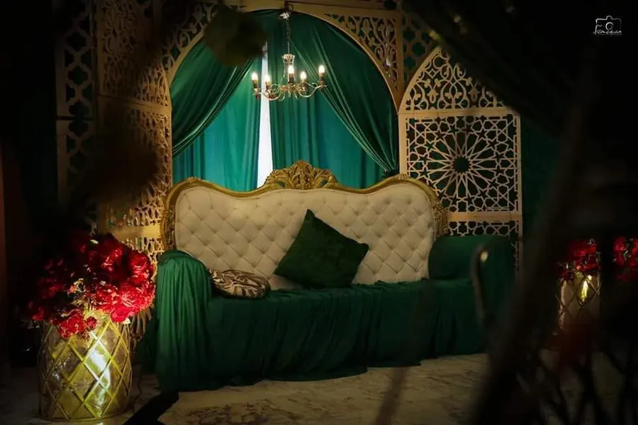 Emerald and gold bridal stage with a chandelier