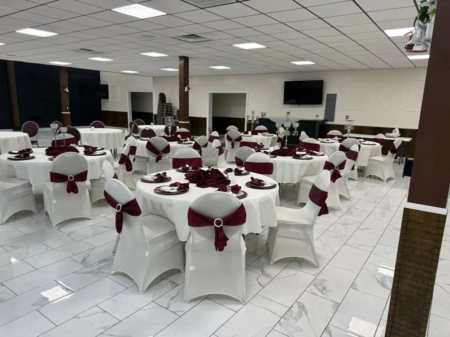 White chairs with burgundy sashes