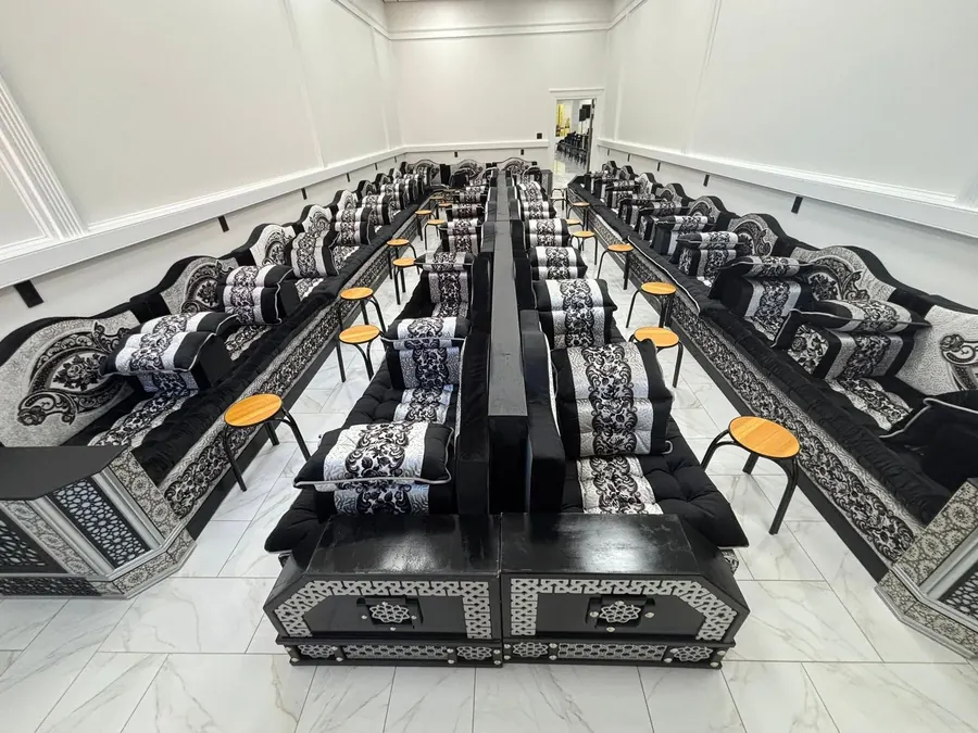 Rows of black and silver majlis floor seating
